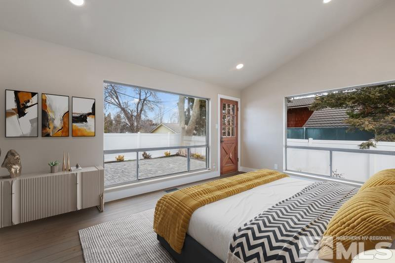 995 Skyline Boulevard Reno, NV 89509 - Photo 27 of 34 a bedroom with a large bed and a flat screen tv