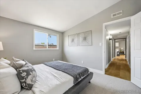 a bedroom with a bed and a painting