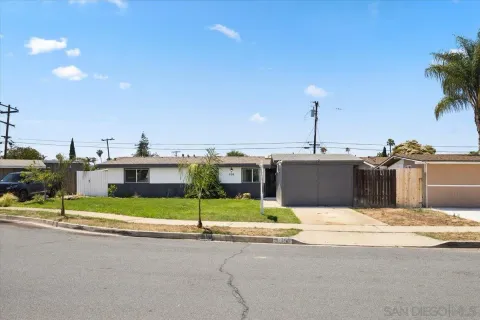 a view of a house with a patio and yard