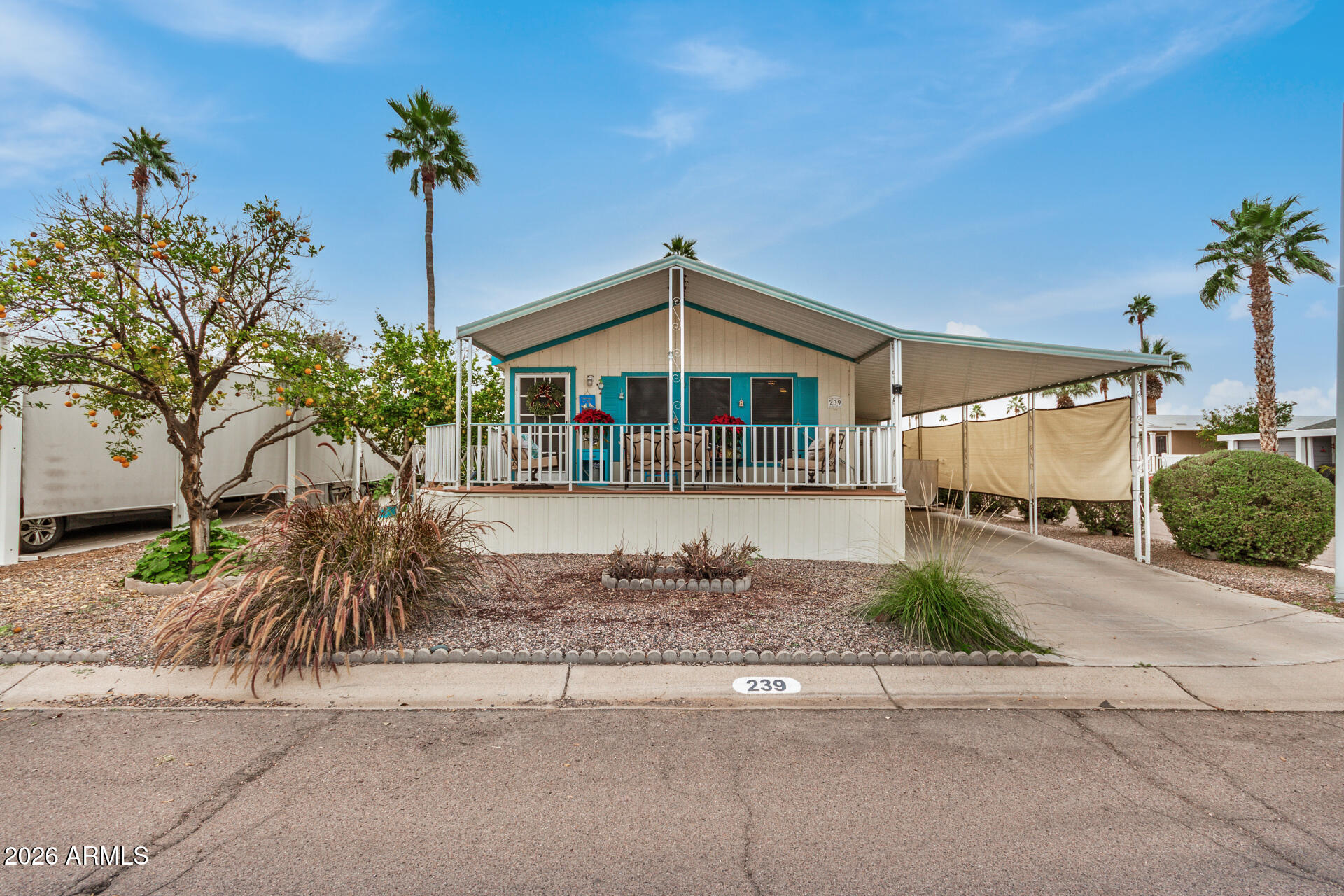 a front view of a house with a yard and potted plants