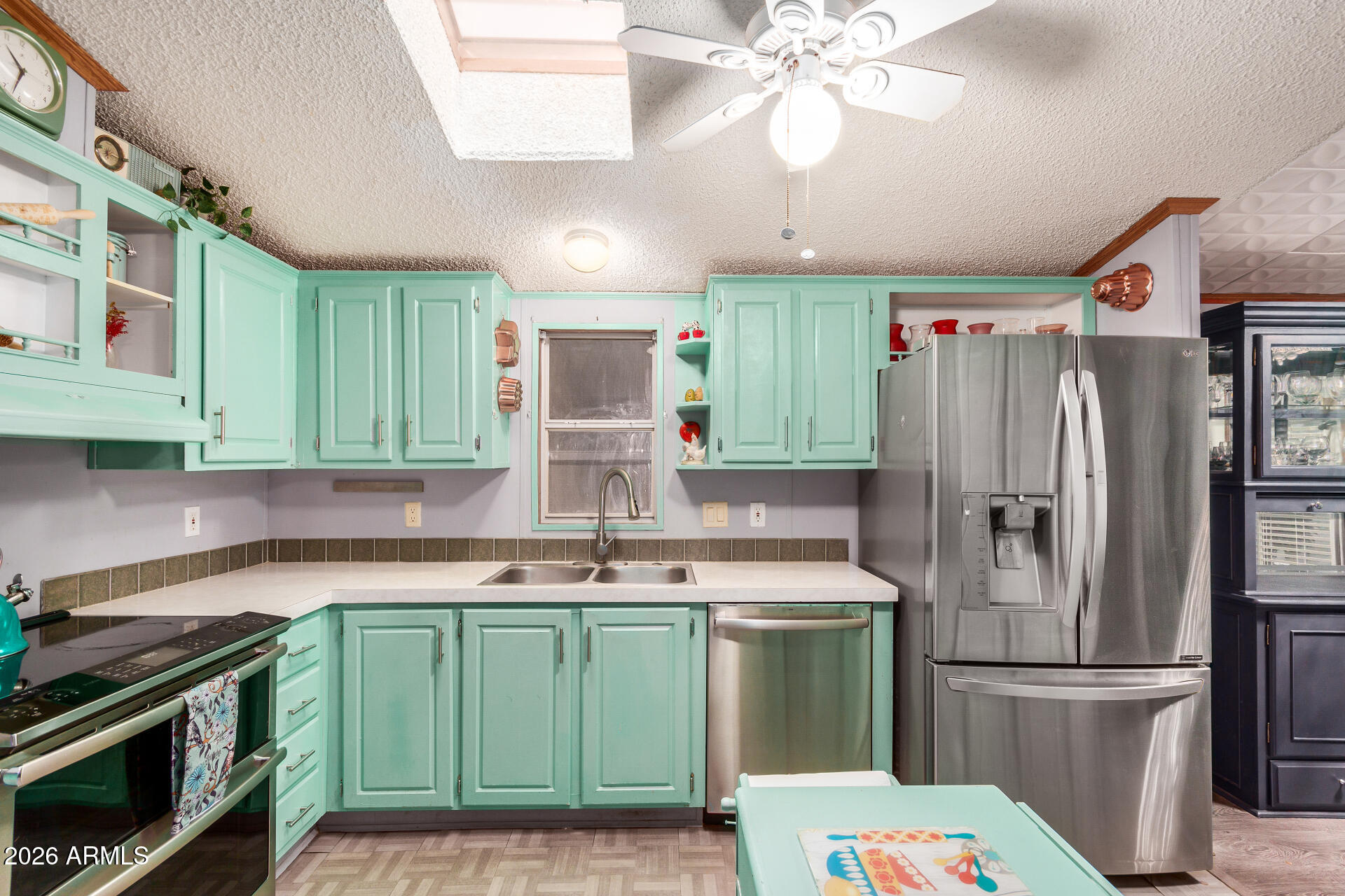 201 South Greenfield Road, Unit 239 Mesa, AZ 85206 - Photo 3 of 32 a kitchen with kitchen island a sink stainless steel appliances and cabinets