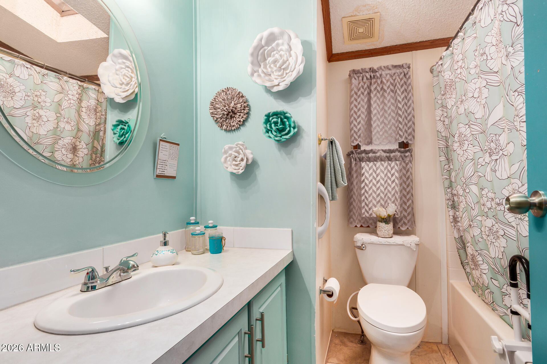 201 South Greenfield Road, Unit 239 Mesa, AZ 85206 - Photo 9 of 32 a bathroom with a toilet sink and mirror