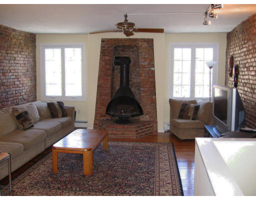 82 Lanark Road, Unit 2 Boston, MA 02135 - Photo 3 of 10 a living room with furniture and a fireplace
