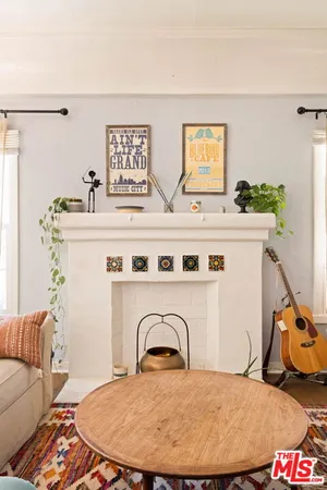a living room with a couch and dresser