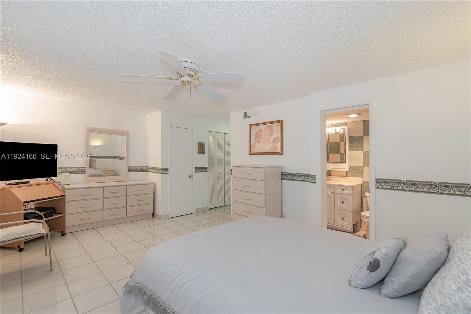 401 Southeast 3rd Street, Unit 507 Dania Beach, FL 33004 - Photo 18 of 28 a bedroom with a bed and a couch