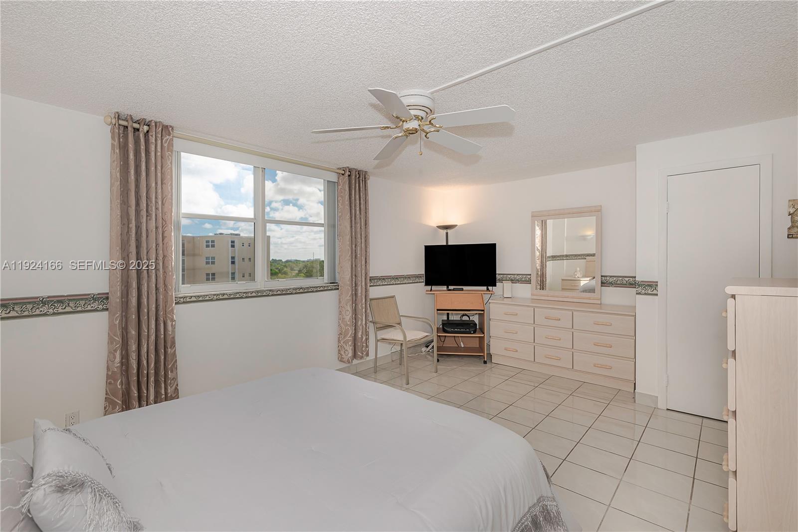 401 Southeast 3rd Street, Unit 507 Dania Beach, FL 33004 - Photo 20 of 28 a bedroom with a bed and a flat screen tv