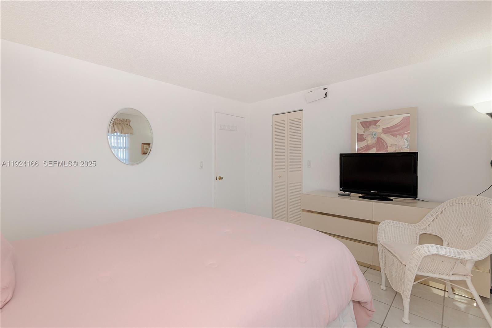 401 Southeast 3rd Street, Unit 507 Dania Beach, FL 33004 - Photo 25 of 28 a bedroom with a bed and a flat screen tv