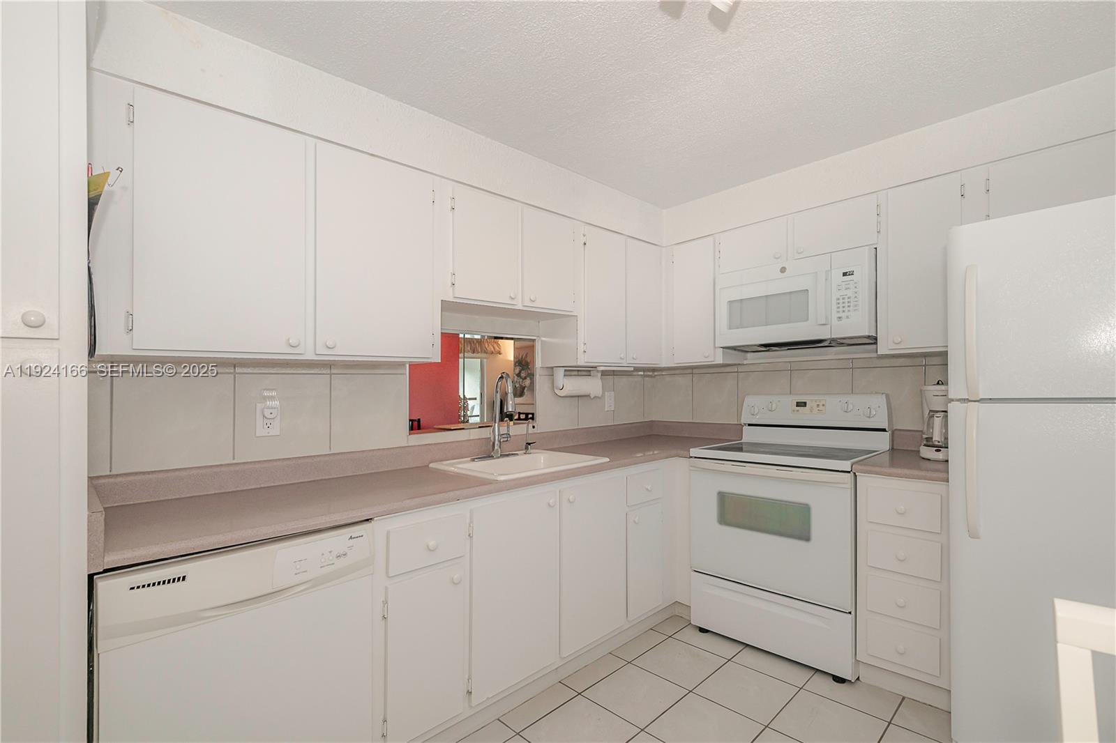 401 Southeast 3rd Street, Unit 507 Dania Beach, FL 33004 - Photo 7 of 28 a kitchen with cabinets appliances a sink and a counter space