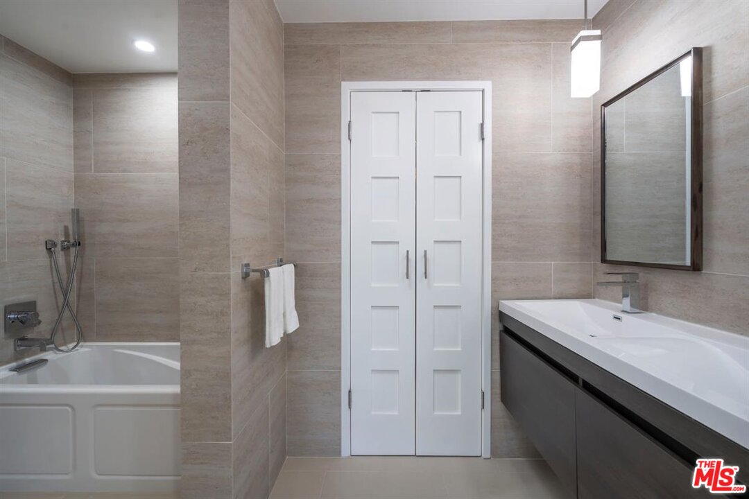 24 Westwind Street, Unit F Marina del Rey, CA 90292 - Photo 17 of 24 a bathroom with a double vanity sink a toilet and shower
