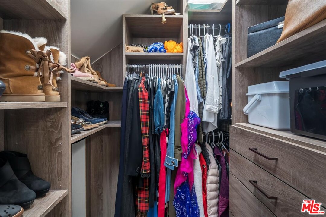 24 Westwind Street, Unit F Marina del Rey, CA 90292 - Photo 18 of 24 a view of walk in closet with clothes and shoes