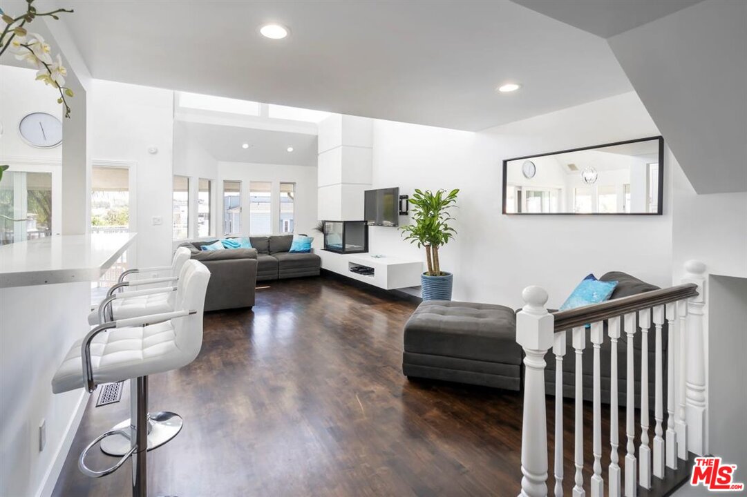 24 Westwind Street, Unit F Marina del Rey, CA 90292 - Photo 4 of 24 a living room with furniture and a large window