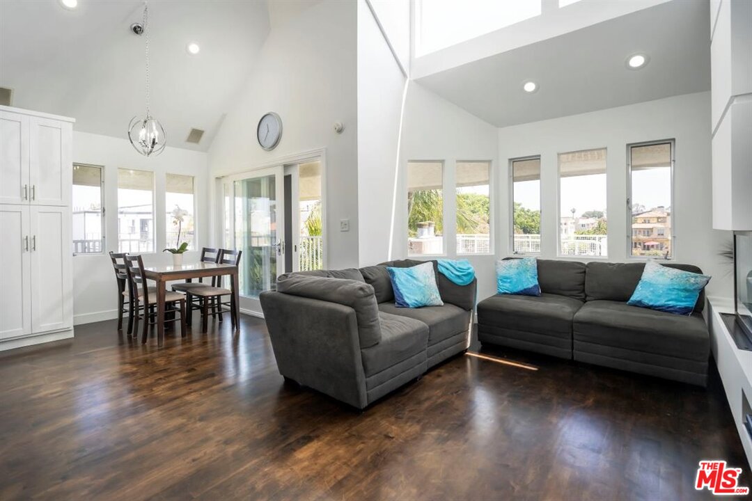 24 Westwind Street, Unit F Marina del Rey, CA 90292 - Photo 5 of 24 a living room with furniture and a large window
