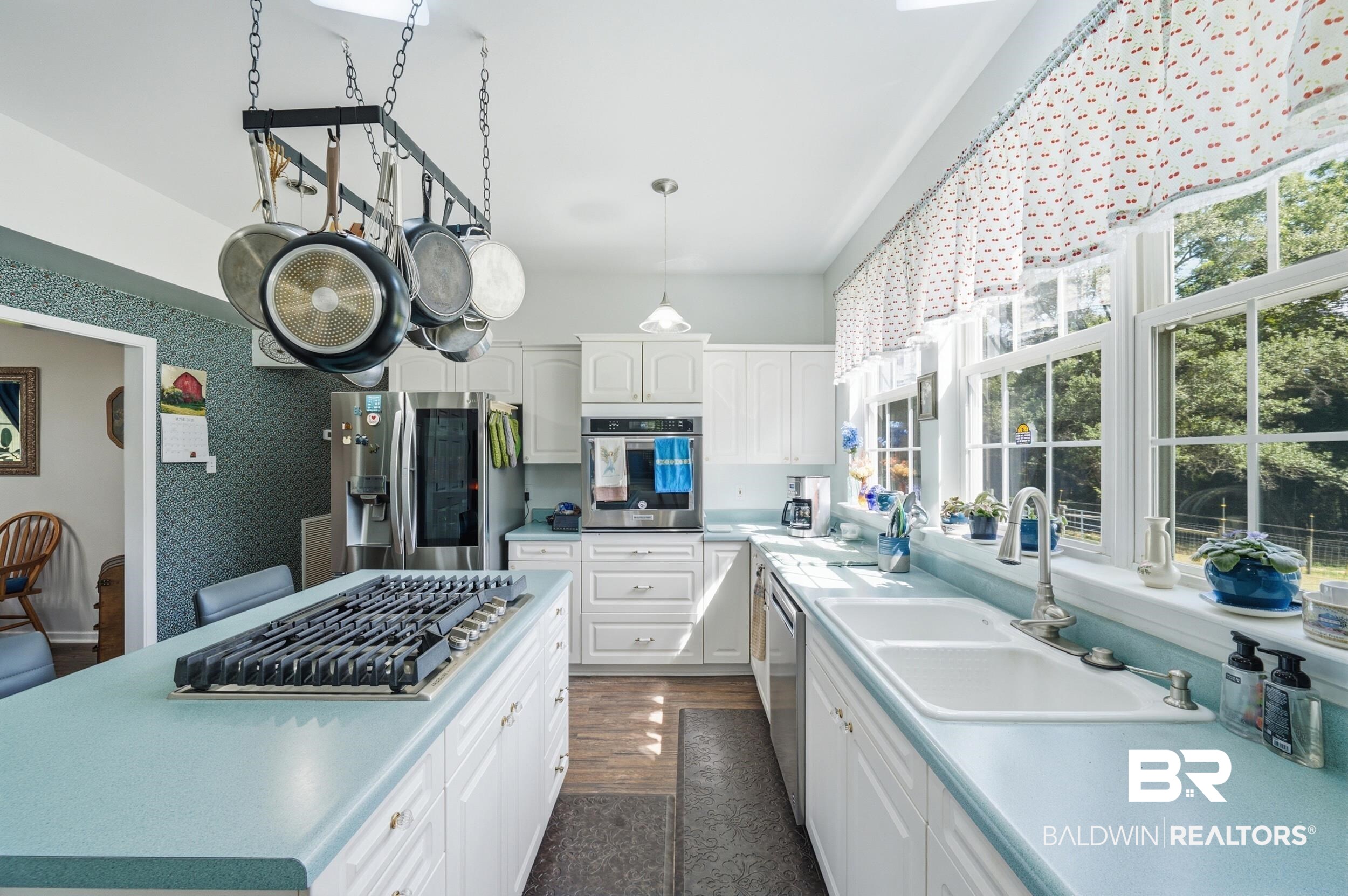 15855 Calvin Richerson Road Bay Minette, AL 36507 - Photo 26 of 83 Kitchen featuring a central island with a gas cooktop, white cabinetry, integrated stainless steel appliances, dual basin sink, and multiple windows