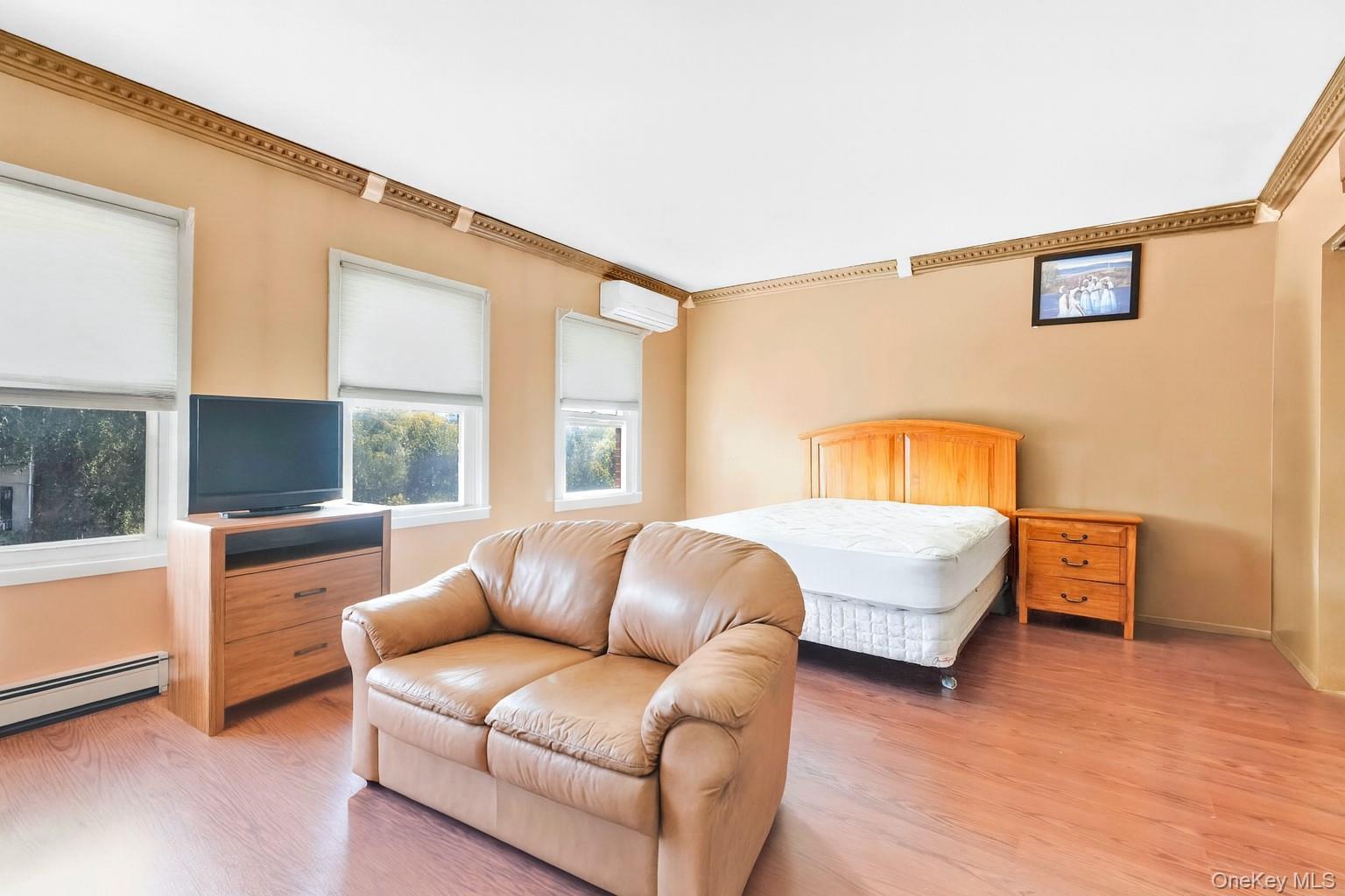 49 Hull Street Brooklyn, NY 11233 - Photo 12 of 31 a bedroom with a bed couch and window