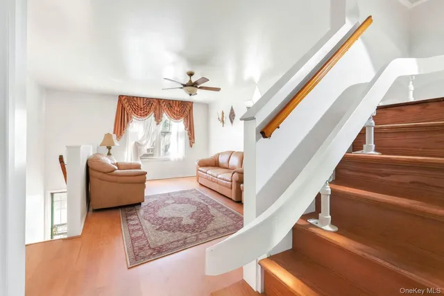 a living room with furniture and a ceiling fan