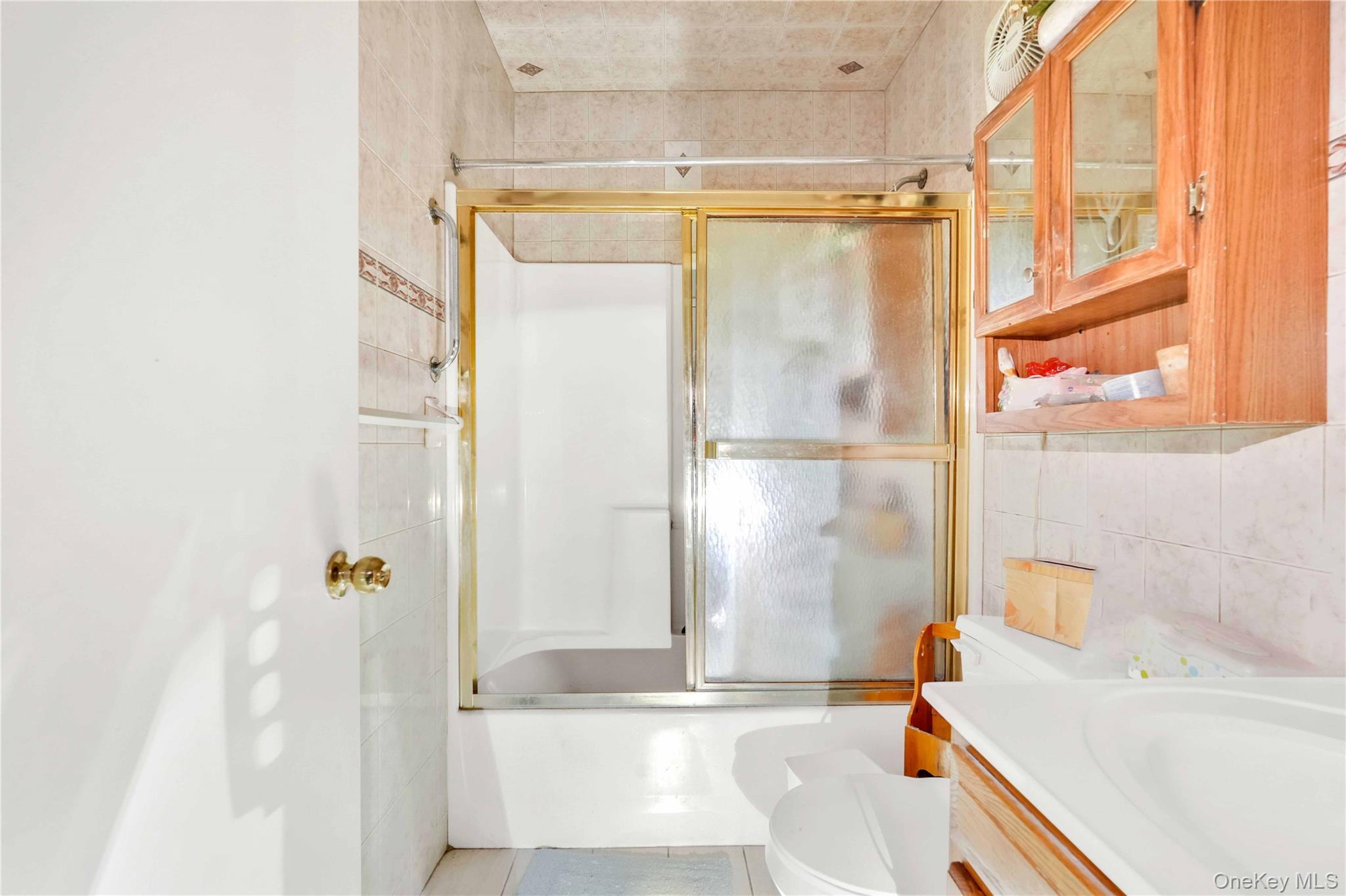 49 Hull Street Brooklyn, NY 11233 - Photo 19 of 31 a bathroom with a tub and shower