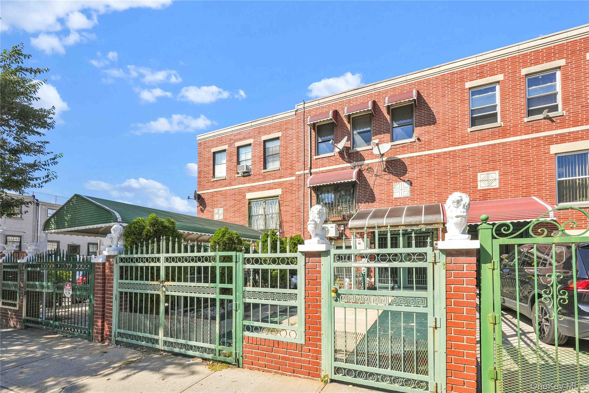 49 Hull Street Brooklyn, NY 11233 - Photo 3 of 31 a front view of a building with glass windows and plants