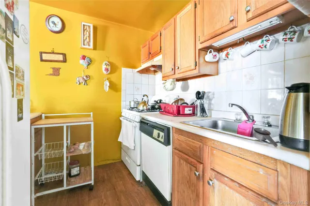 a kitchen with a sink and wooden cabinets