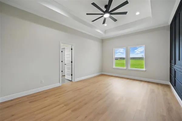 a view of an empty room with wooden floor