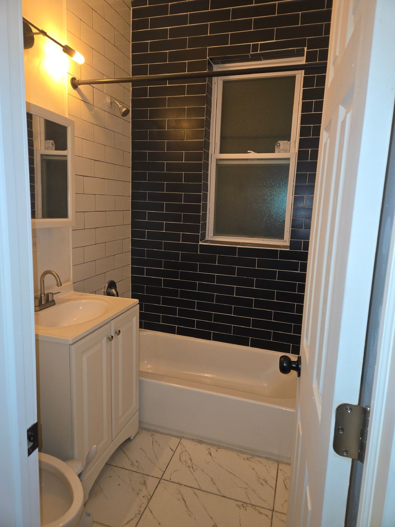 6229 South Bishop Street, Unit 1 Chicago, IL 60636 - Photo 3 of 17 a bathroom with a bathtub and a shower