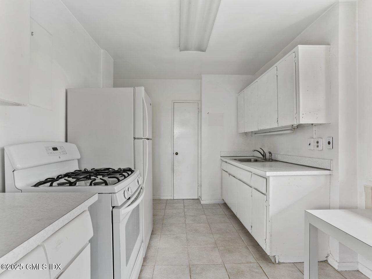 3 Putnam Hill, Unit 2B Greenwich, CT 06830 - Photo 12 of 23 a kitchen with granite countertop a sink a stove and refrigerator