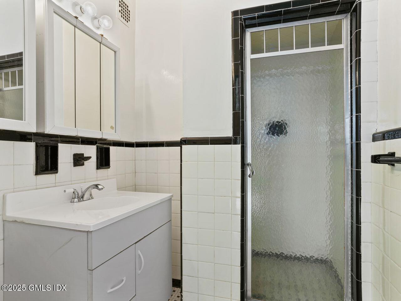 3 Putnam Hill, Unit 2B Greenwich, CT 06830 - Photo 17 of 23 a bathroom with a sink and mirror