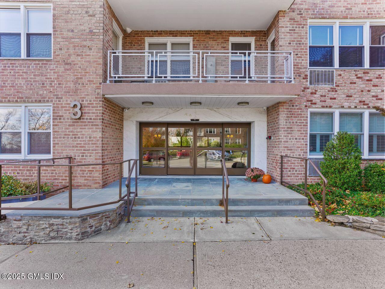 3 Putnam Hill, Unit 2B Greenwich, CT 06830 - Photo 2 of 23 a front view of a building with glass windows and door