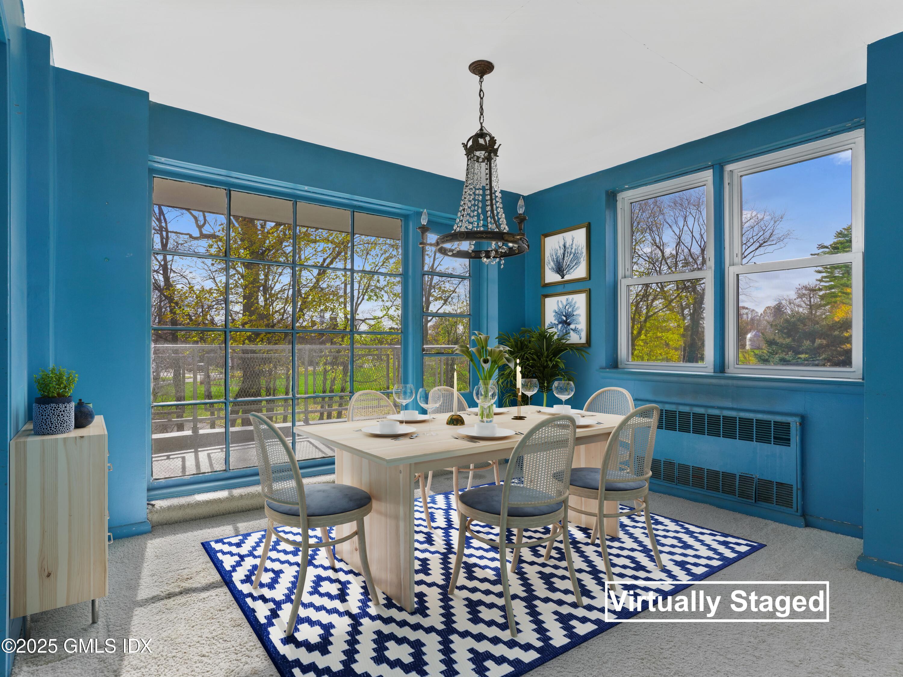 3 Putnam Hill, Unit 2B Greenwich, CT 06830 - Photo 10 of 23 a dining room with furniture a chandelier and wooden floor