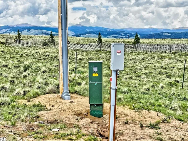 a view of a street sign and tall trees