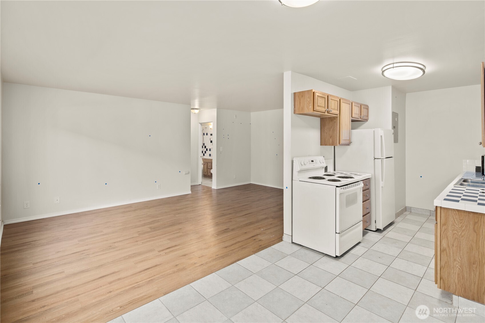 509 19th Avenue East Seattle, WA 98112 - Photo 12 of 40 a view of a kitchen with white cabinets and wooden floor