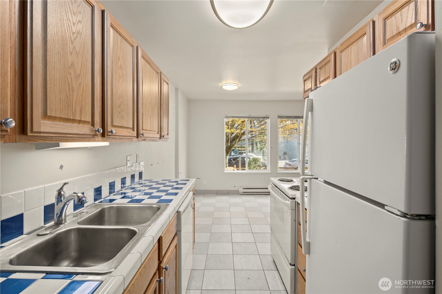 509 19th Avenue East Seattle, WA 98112 - Photo 15 of 40 a kitchen with stainless steel appliances granite countertop a sink stove and refrigerator