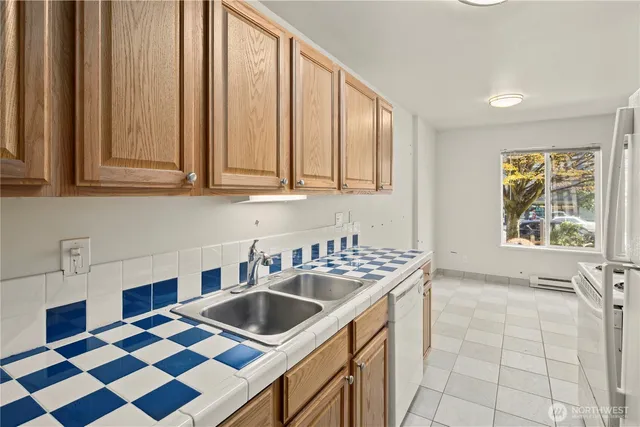 a kitchen that has a sink and a stove