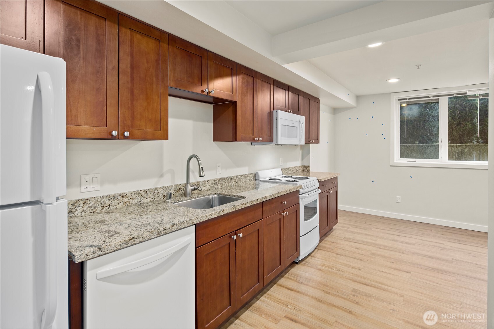 509 19th Avenue East Seattle, WA 98112 - Photo 22 of 40 a kitchen with a sink stove and cabinets