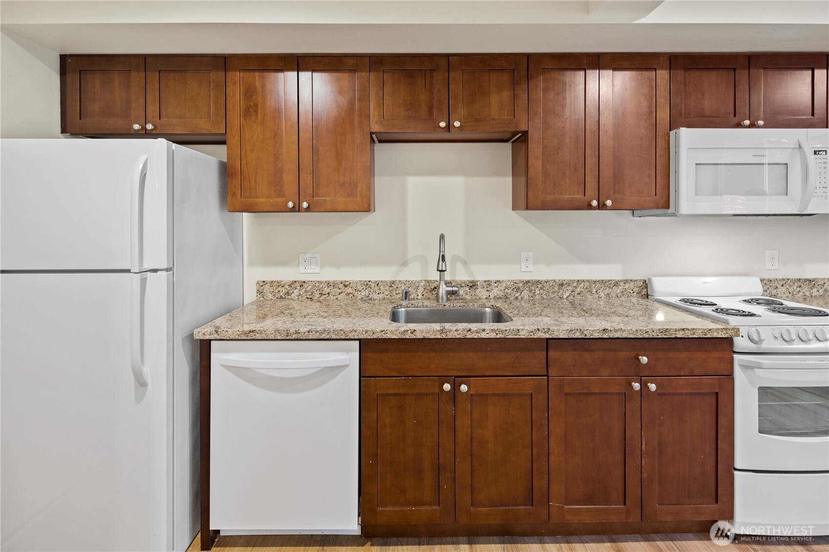 509 19th Avenue East Seattle, WA 98112 - Photo 23 of 40 a kitchen with a sink a cabinetry and refrigerator