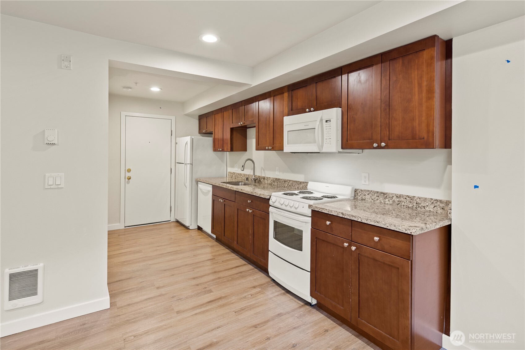 509 19th Avenue East Seattle, WA 98112 - Photo 24 of 40 a kitchen with stainless steel appliances granite countertop a stove a sink and a microwave