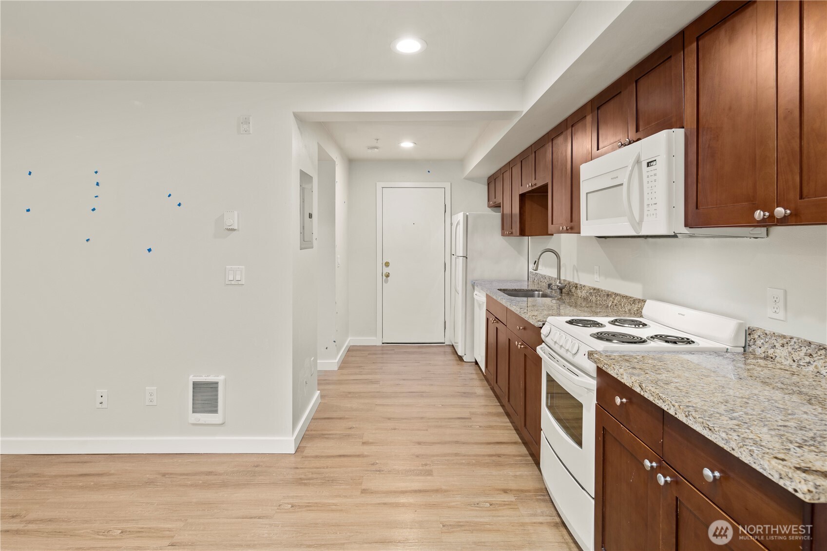 509 19th Avenue East Seattle, WA 98112 - Photo 25 of 40 a kitchen with stainless steel appliances granite countertop a stove a sink and a refrigerator