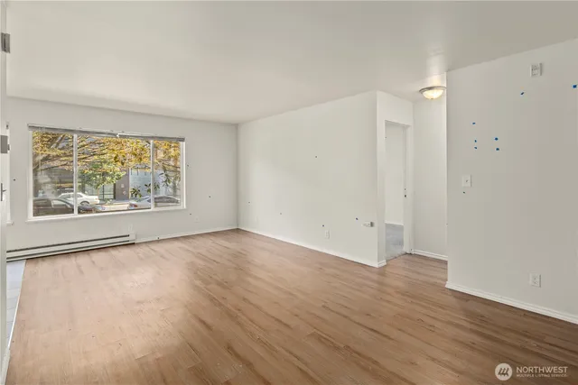 wooden floor in an empty room with a window