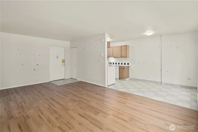 a view of kitchen with wooden floor and electronic appliances