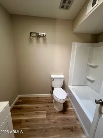 a bathroom with a toilet and a tub