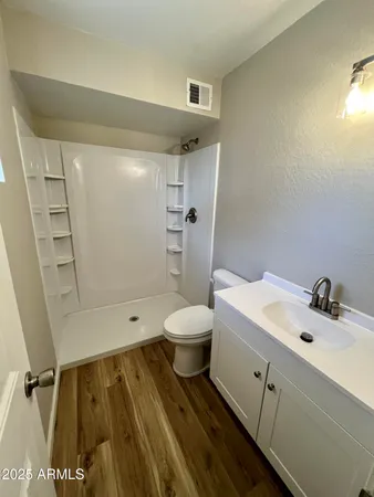 a bathroom with a sink toilet and shower