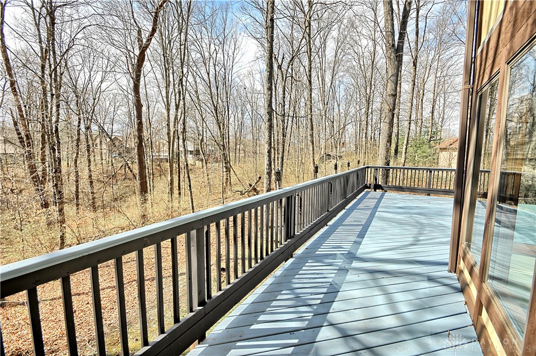 8711 Nicole Lane Springboro, OH 45066 - Photo 75 of 87 Enjoy tranquil woodland views from this expansive deck, perfect for peaceful mornings or entertaining.
