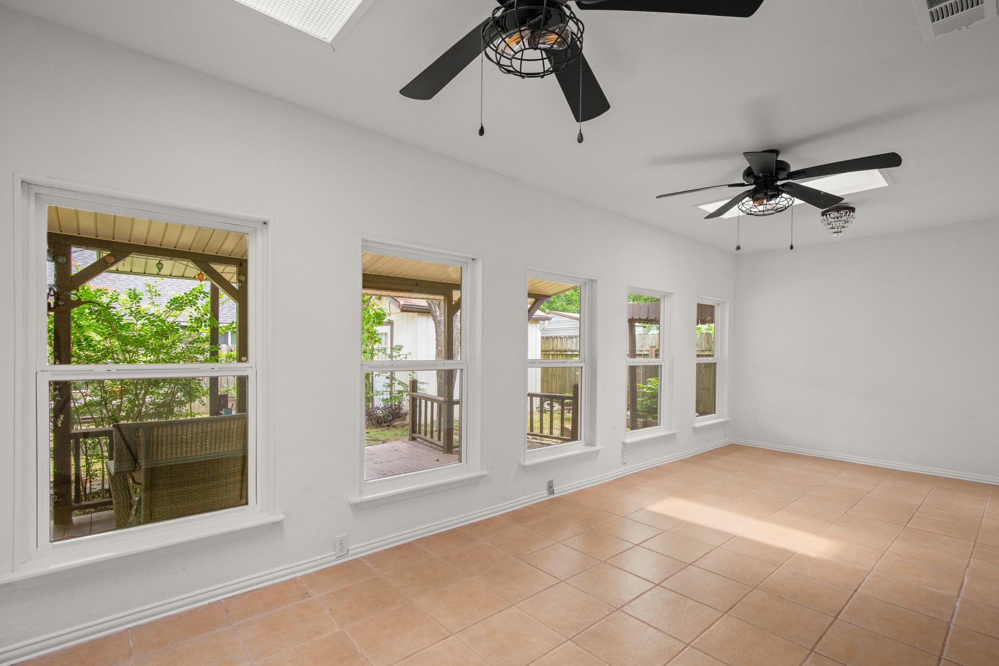 2109 Brandywine Lane Austin, TX 78727 - Photo 12 of 27 Sunroom with ceiling fan and light tile patterned flooring