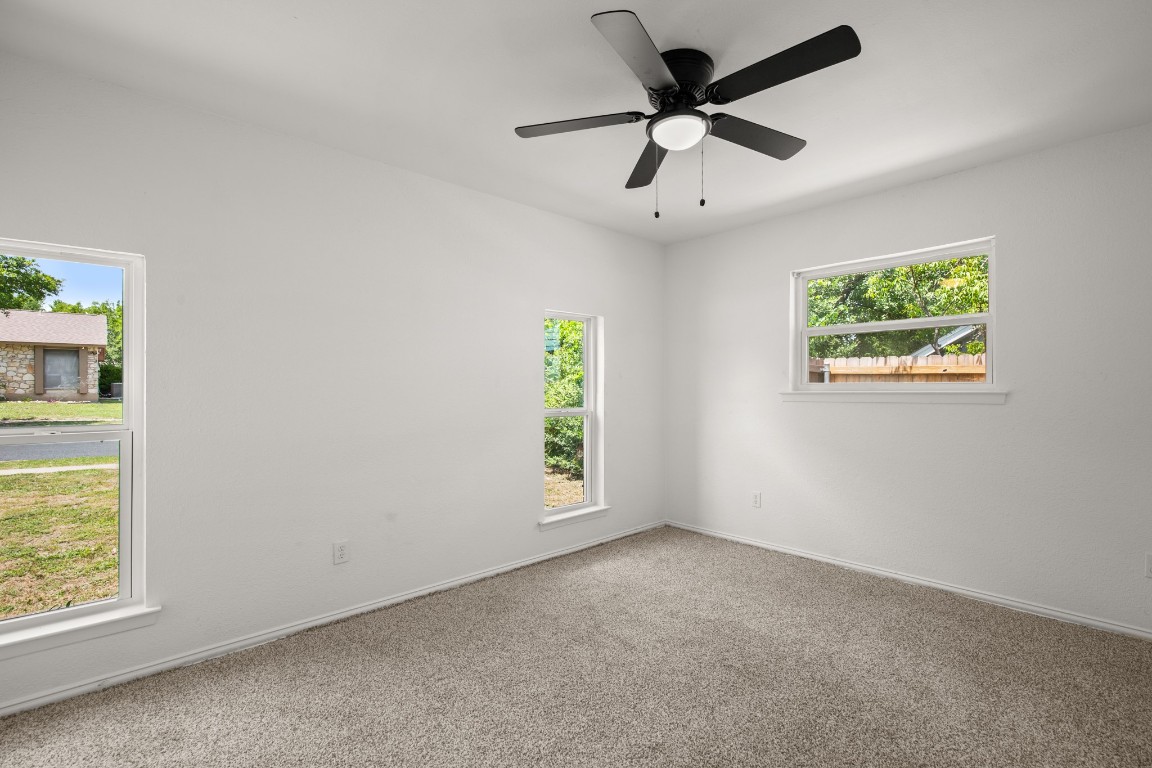 2109 Brandywine Lane Austin, TX 78727 - Photo 14 of 27 an empty room with windows and fan