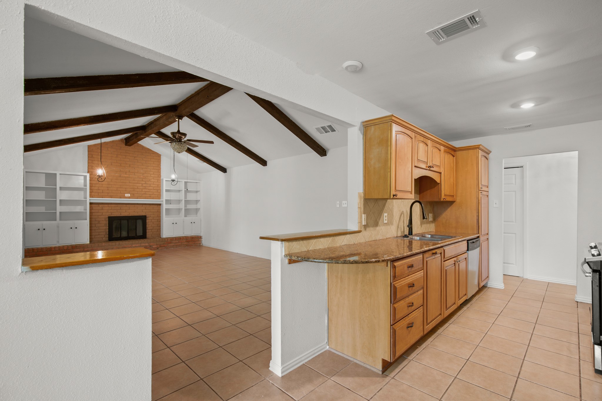 2109 Brandywine Lane Austin, TX 78727 - Photo 7 of 27 Kitchen with light tile patterned floors, stainless steel dishwasher, ceiling fan, recessed lighting, and decorative backsplash