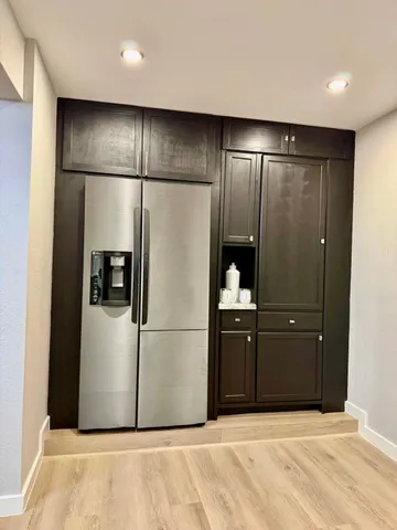 a view of a patio with couches table and chairs and potted plants