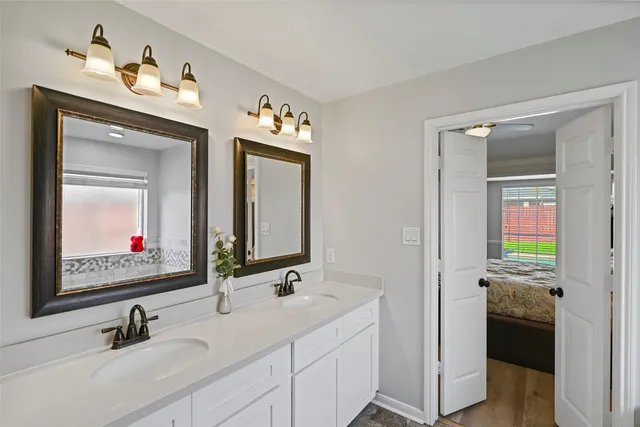 a view of staircase with lots of frames on wall and wooden floor