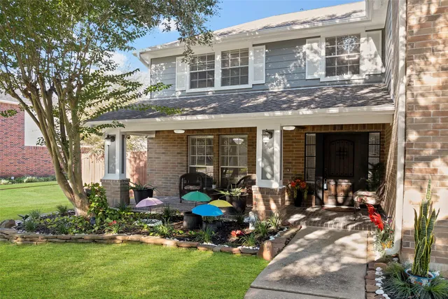 a front view of a house with a garden and sitting area