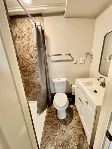a bathroom with a granite countertop sink mirror and double