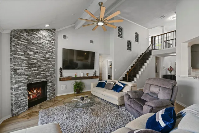 a living room with furniture fireplace and flat screen tv