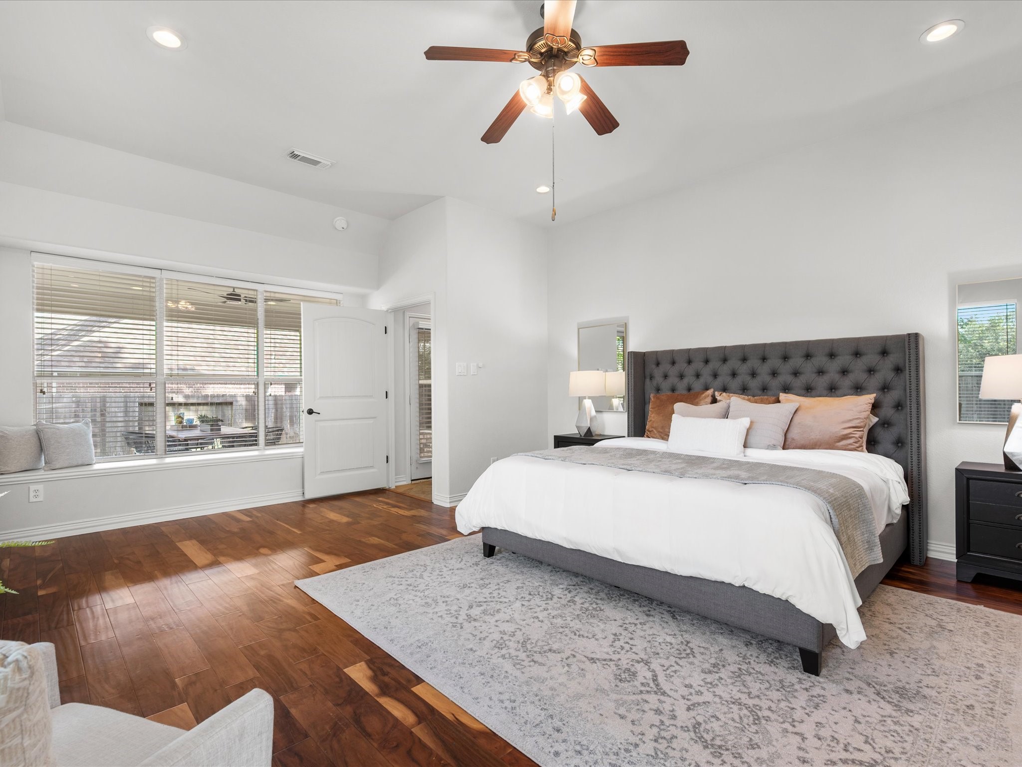 323 Arbor Ridge Lane Conroe, TX 77384 - Photo 19 of 40 Primary suite on the main floor, because nobody wants to climb stairs at bedtime. Wood floors, big windows, and room for a king with space to spare. Your retreat awaits.